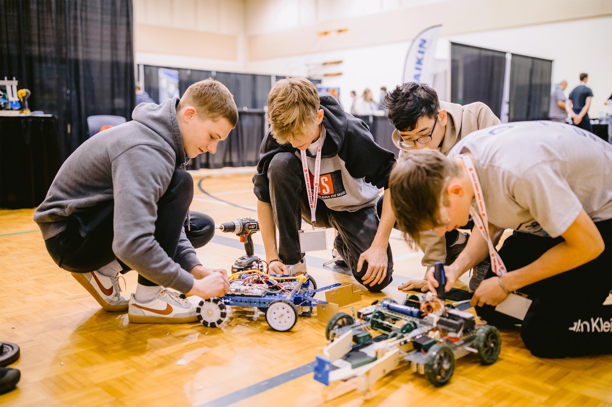 Students repairing a robotic vehicle.